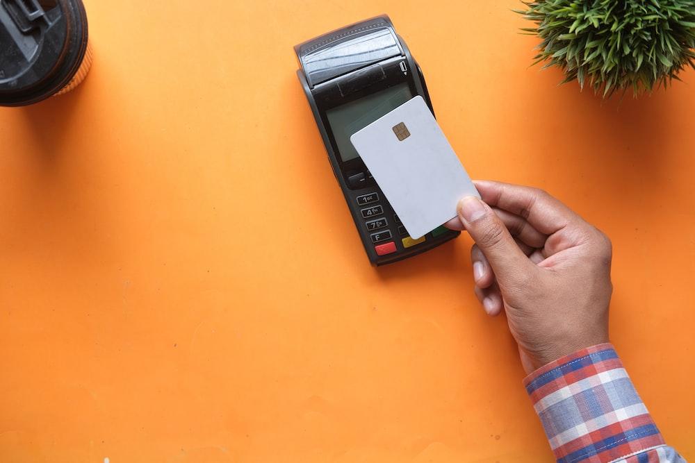 person using a credit card at POS