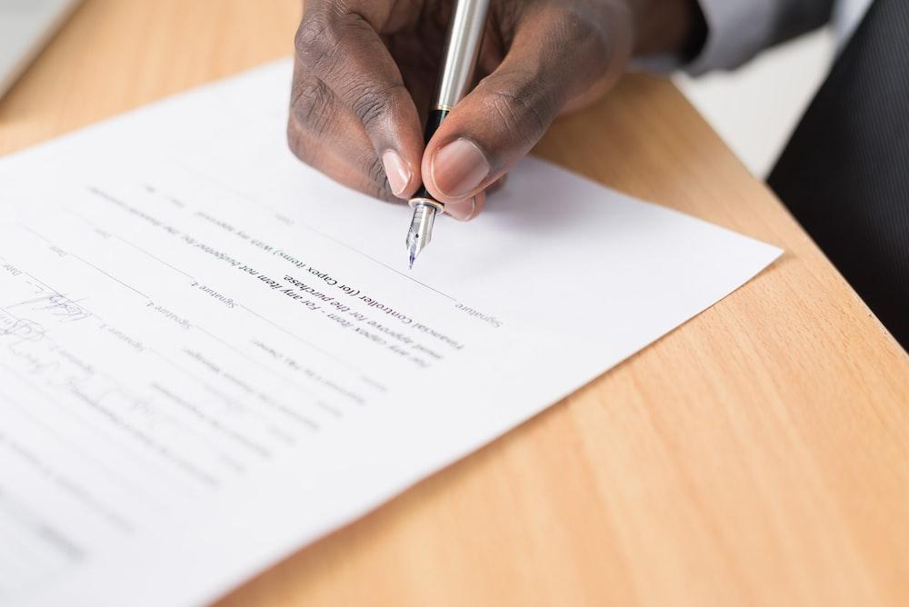 person signing a contract. 