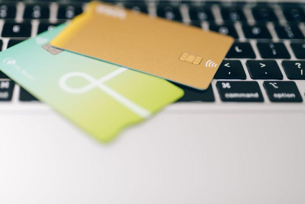 credit cards on top of a laptop. 