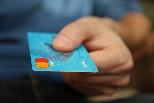 An individual holding a credit card