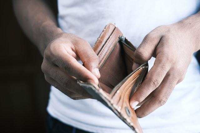 An individual holding an empty wallet