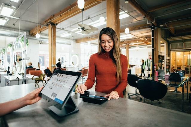 A girl using her credit card at a local shop