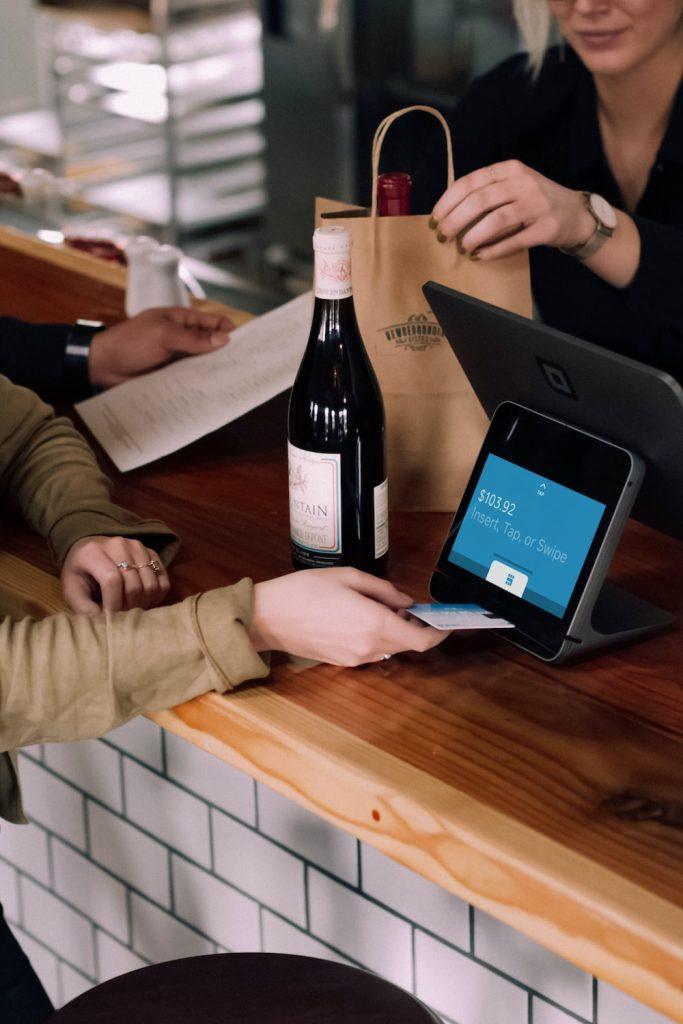 A customer buying wine using their credit card