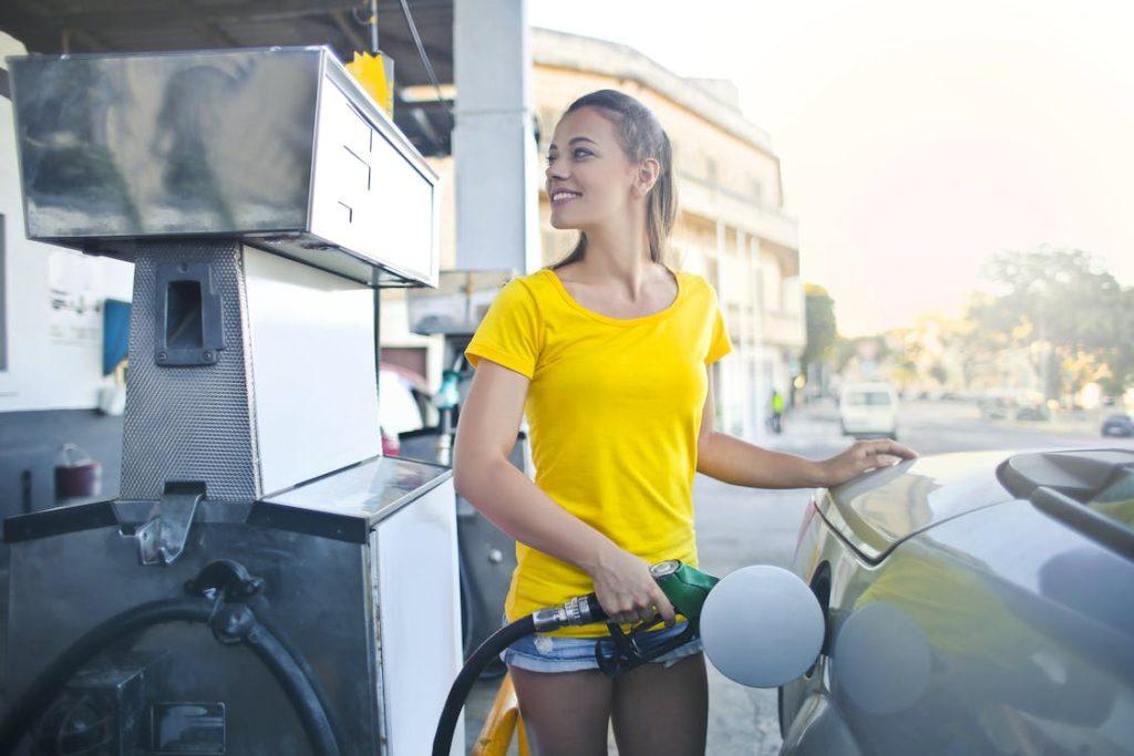 A woman refuelling a car