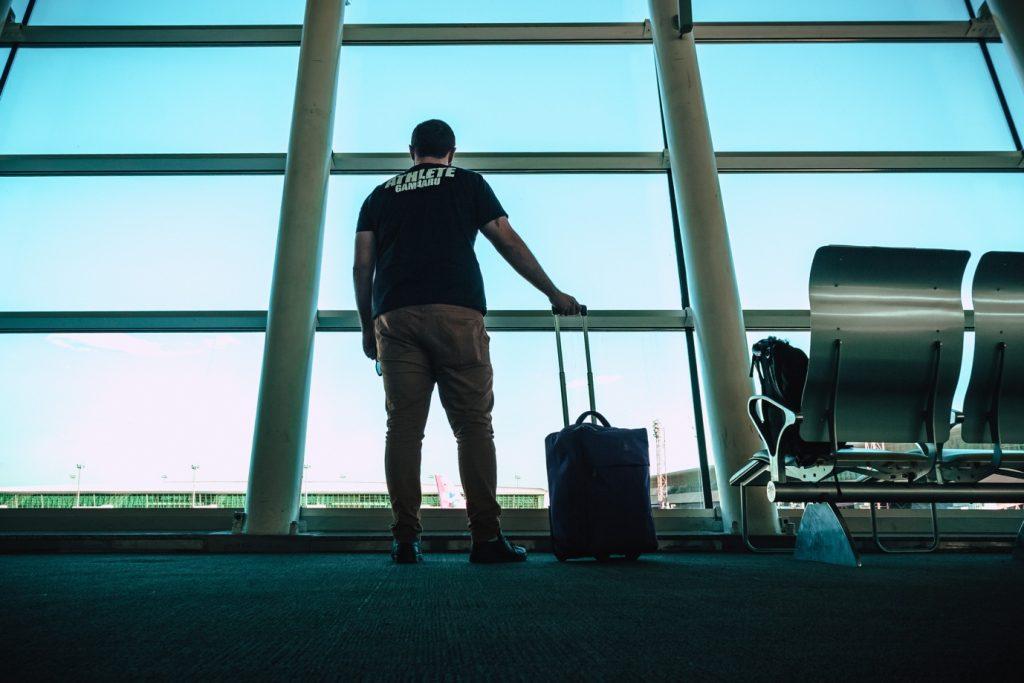 A man with his luggage at the airport