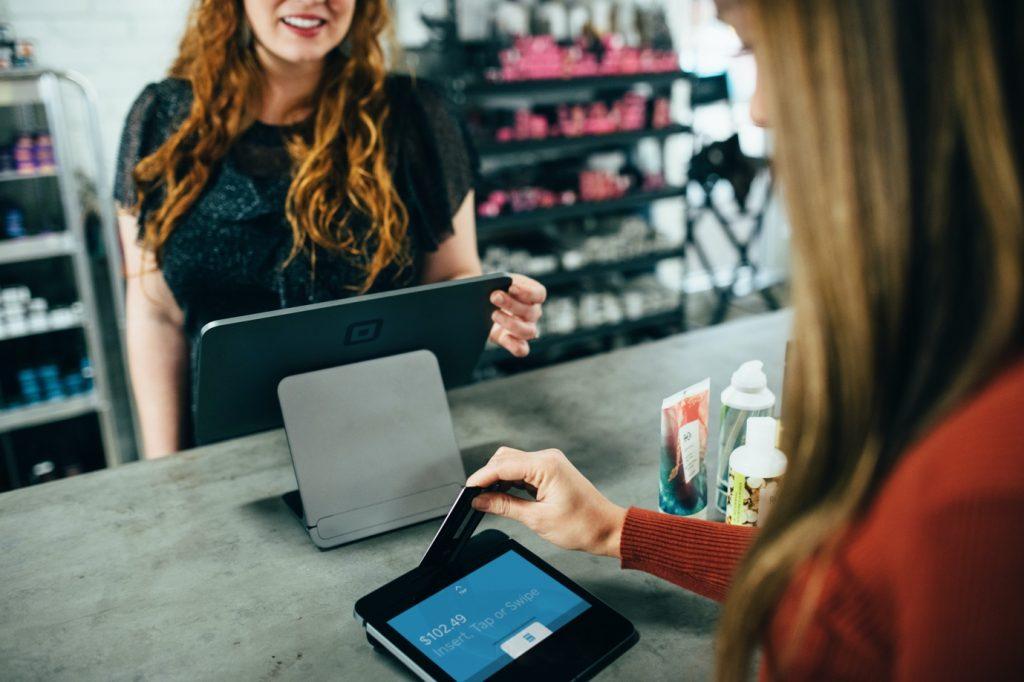 A woman paying through a credit card