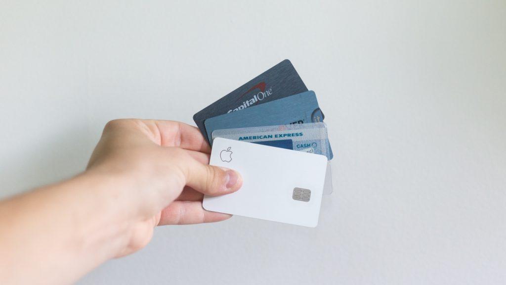 A person holding multiple credit cards