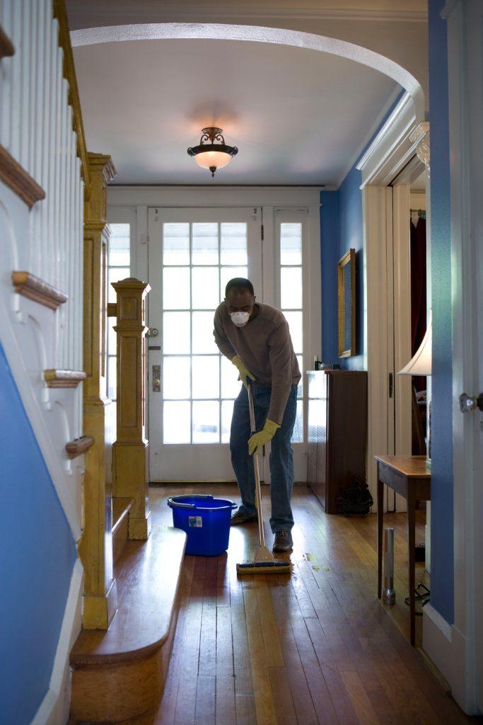 A man cleaning his home’s floor