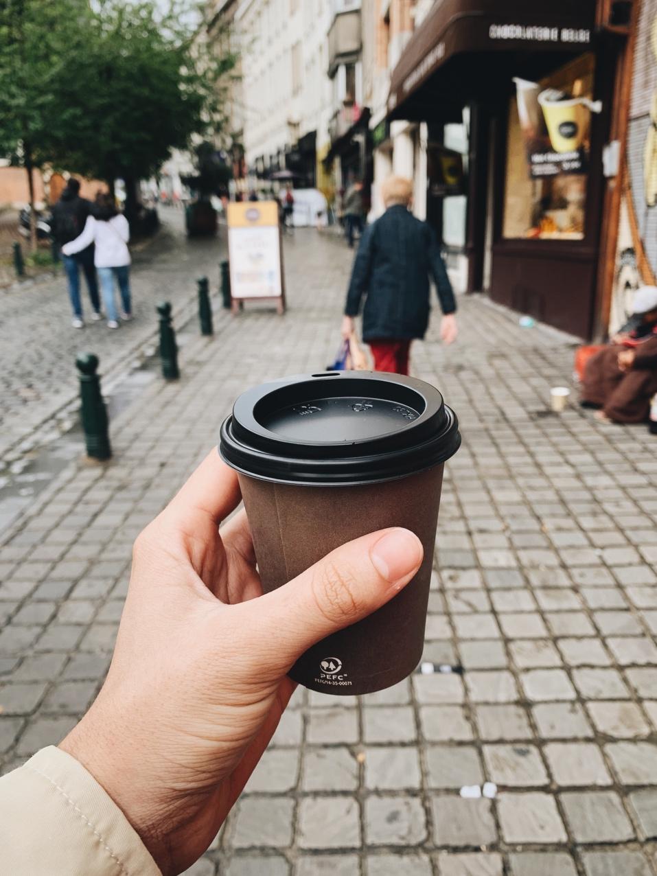 A person holding a cup of coffee