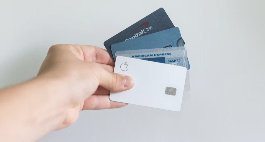Person holding different types of credit cards.