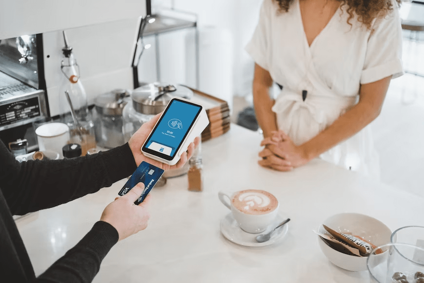 A person paying through a credit card machine