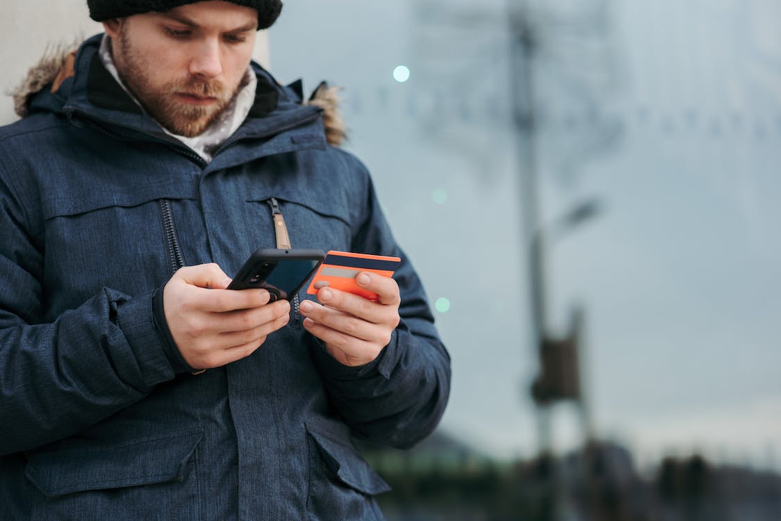 A man is holding a credit card