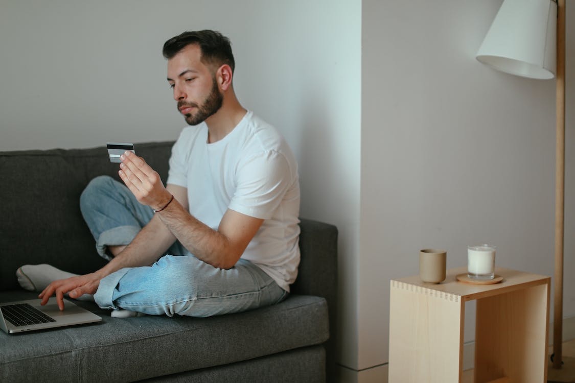 A man is looking at his credit card details