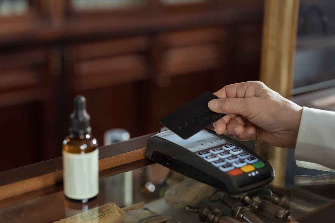 a person holding a black credit card