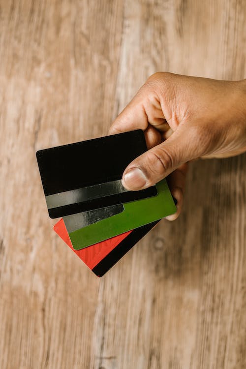 a person holding several credit cards