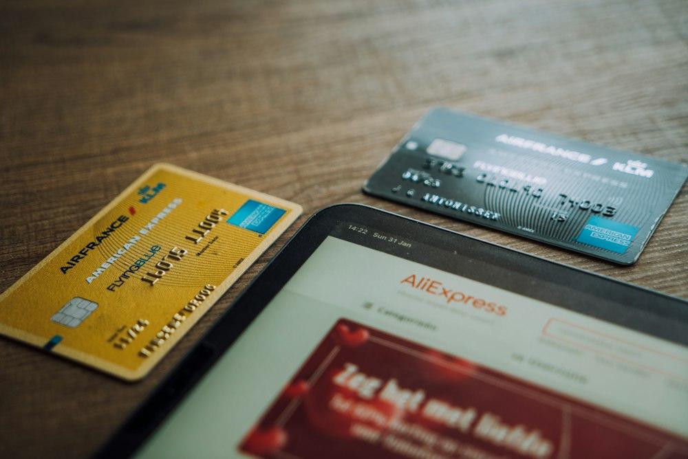 credit cards next to a tablet