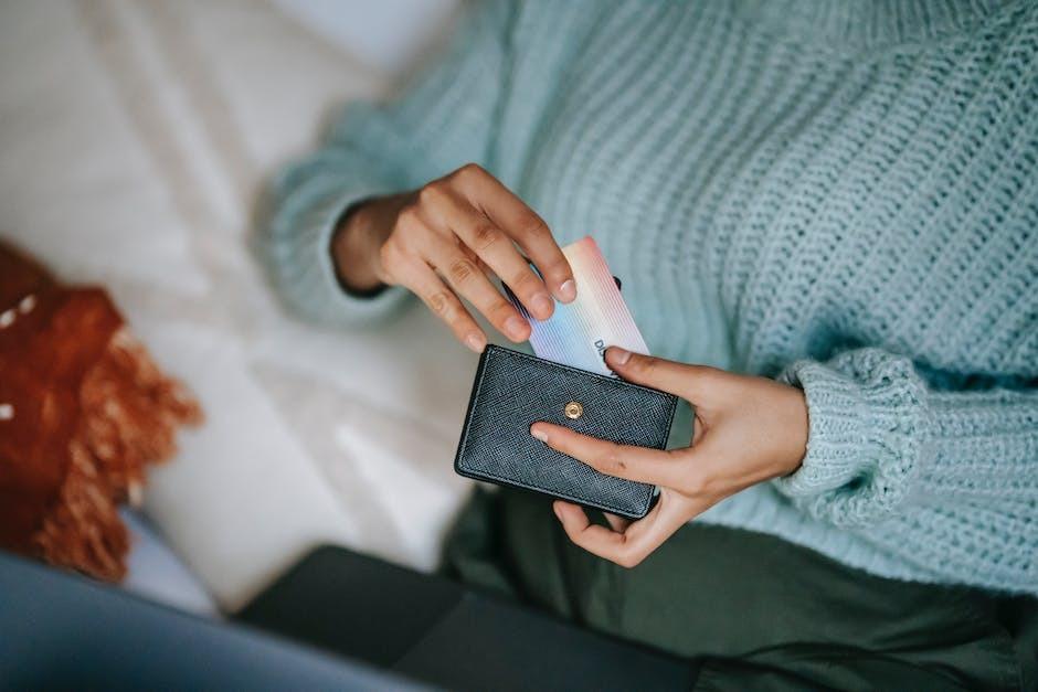 A woman is taking out a credit card