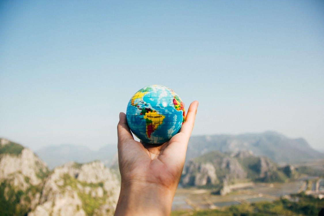 a person holding world globe