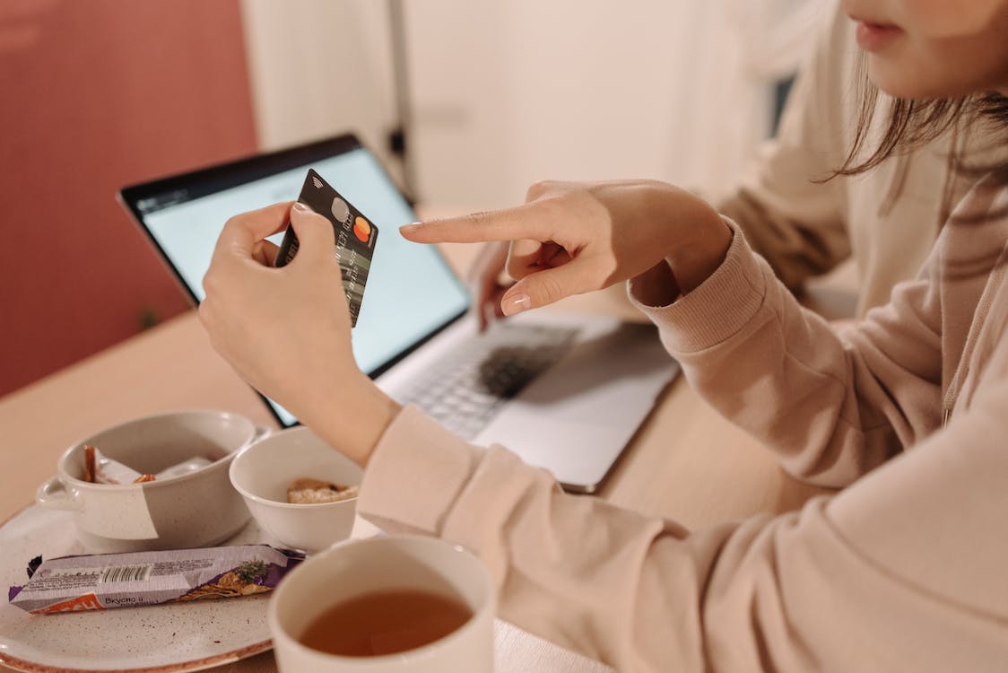 woman pointing at a credit card